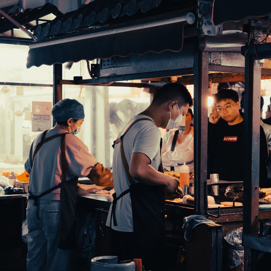 Cooks working a busy street food stall